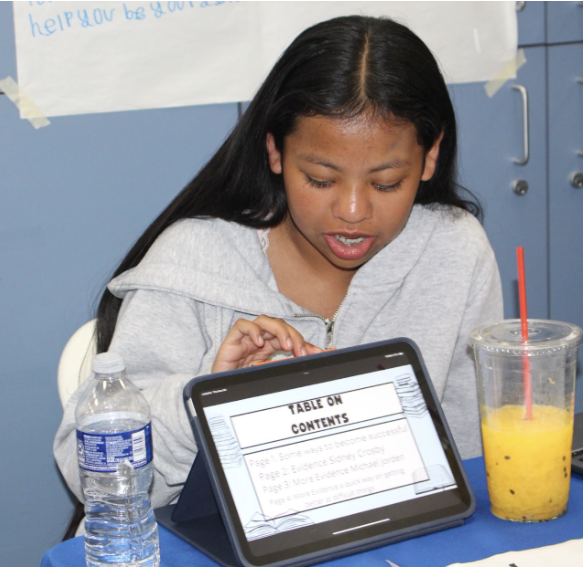 A Hidden Valley Middle School student reviewing her digital portfolio on a tablet
