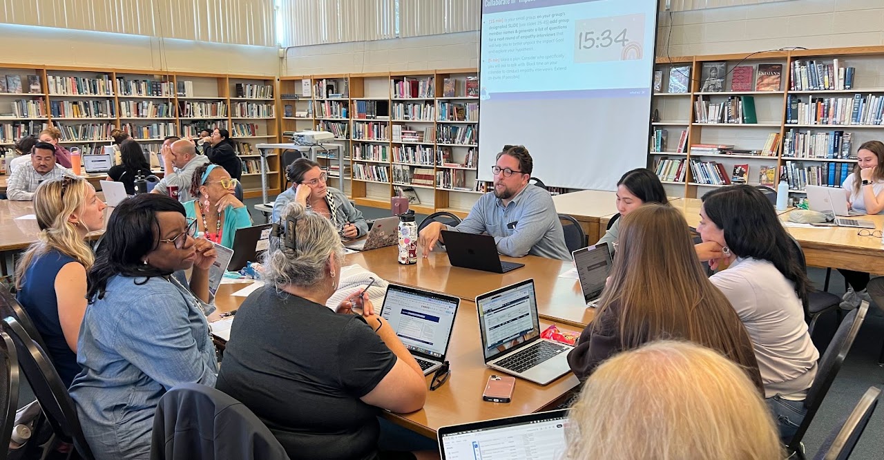 A Design Team meeting together in a library